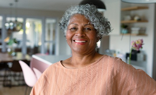 Closeup of woman smiling in kitchen