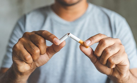 Closeup of patient breaking cigarette