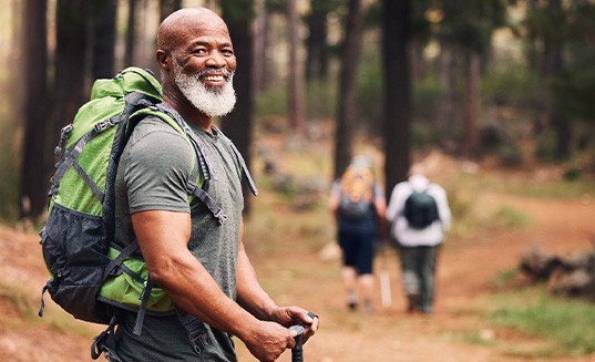 Senior man smiling on hiking trail