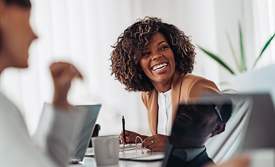 Female professional showing off a smile with dental implants in Cary