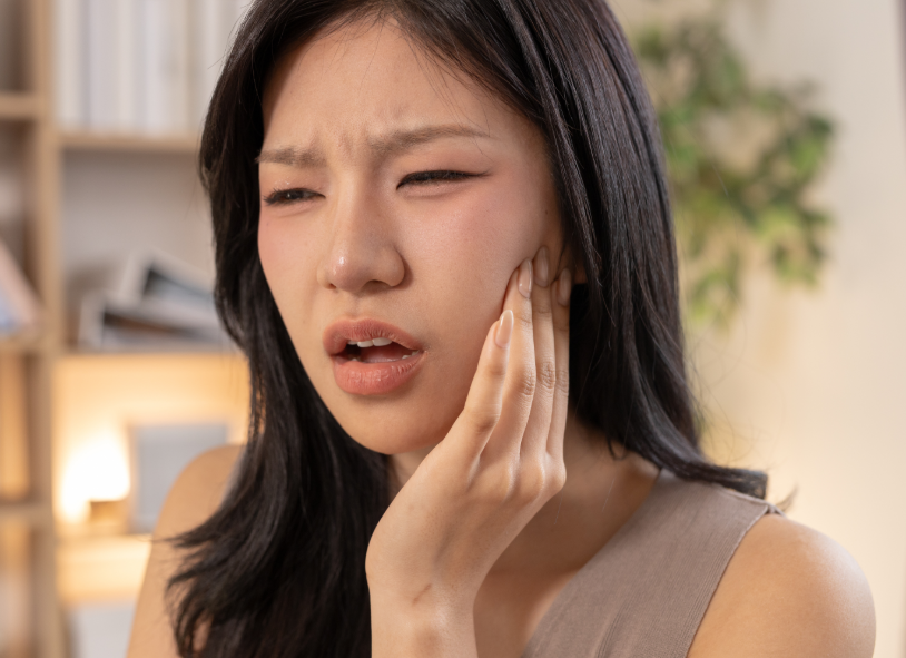 Woman holding jaw in pain